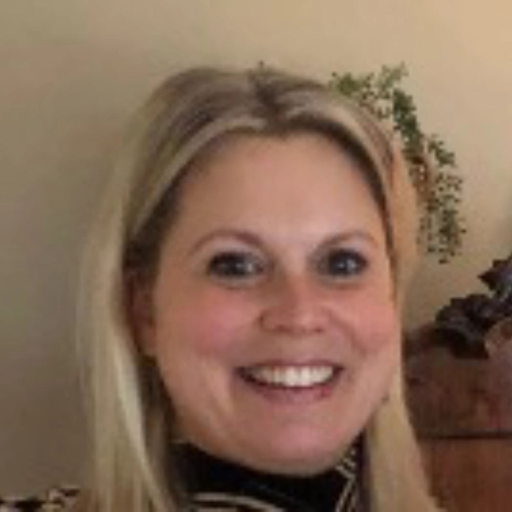 Smiling woman with blonde hair indoors